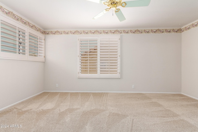 spare room featuring carpet floors and ceiling fan