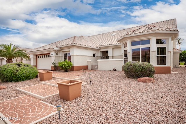 mediterranean / spanish house with a garage