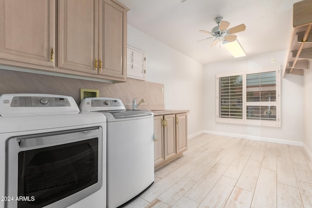 laundry area with sink, washing machine and clothes dryer, ceiling fan, cabinets, and light hardwood / wood-style flooring