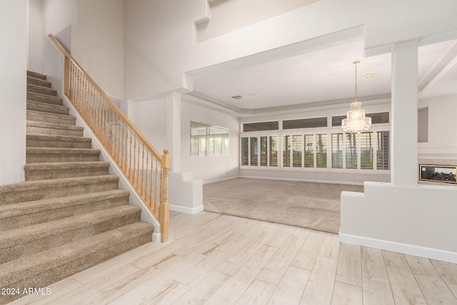 interior space with hardwood / wood-style flooring, an inviting chandelier, and plenty of natural light