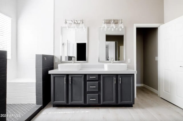 bathroom with vanity, a shower, and hardwood / wood-style flooring