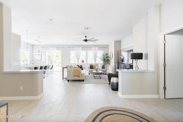 living room featuring ceiling fan and light hardwood / wood-style flooring