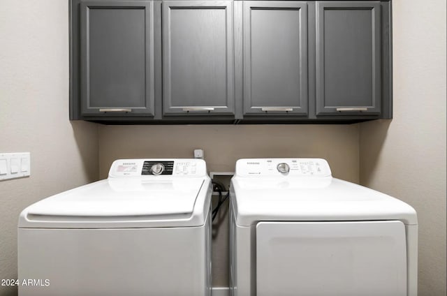 washroom with cabinets and separate washer and dryer