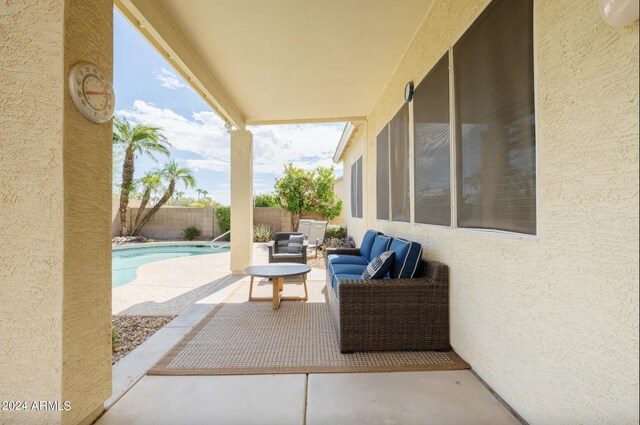 view of patio with a fenced in pool and outdoor lounge area