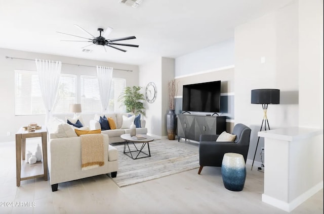 living room with ceiling fan and light wood-type flooring