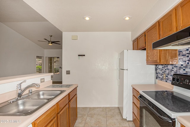 8140 N 107th Ave Unit 287, Peoria, AZ 85345 - kitchen with range with electric stovetop, a sink, brown cabinetry, decorative backsplash, and light countertops