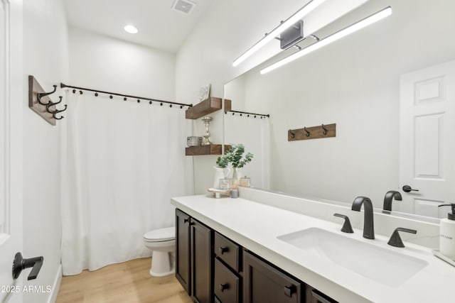 full bathroom with visible vents, toilet, wood finished floors, recessed lighting, and vanity