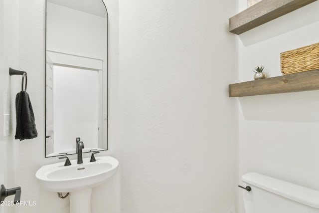 bathroom featuring a sink and toilet