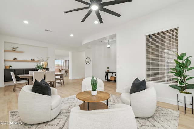 living area featuring recessed lighting, visible vents, light wood-style floors, and ceiling fan