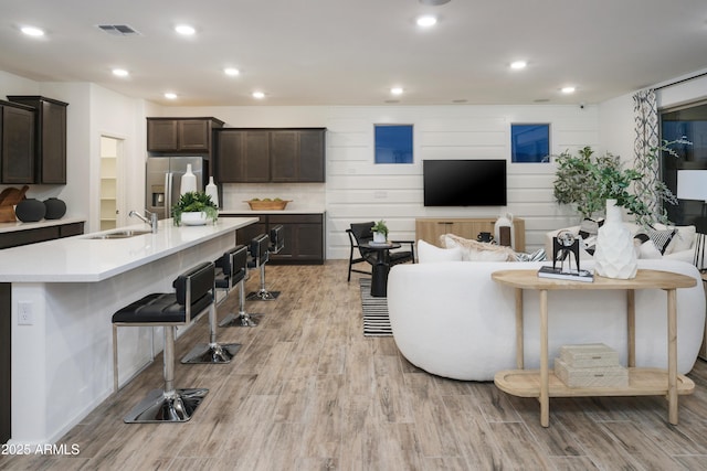 living room featuring light hardwood / wood-style floors and sink