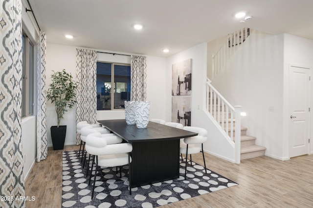 dining space with light hardwood / wood-style floors