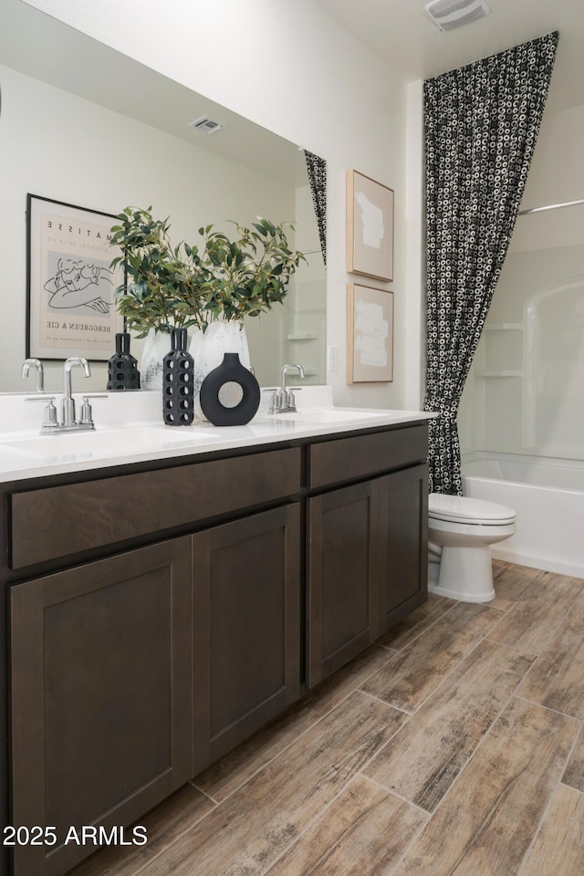 full bathroom with shower / bath combo, toilet, and vanity