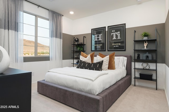 bedroom featuring a mountain view and light carpet