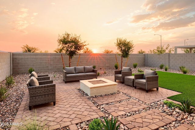 patio terrace at dusk featuring an outdoor living space with a fire pit