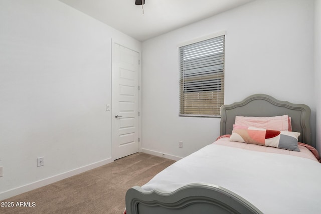 bedroom with ceiling fan and light colored carpet