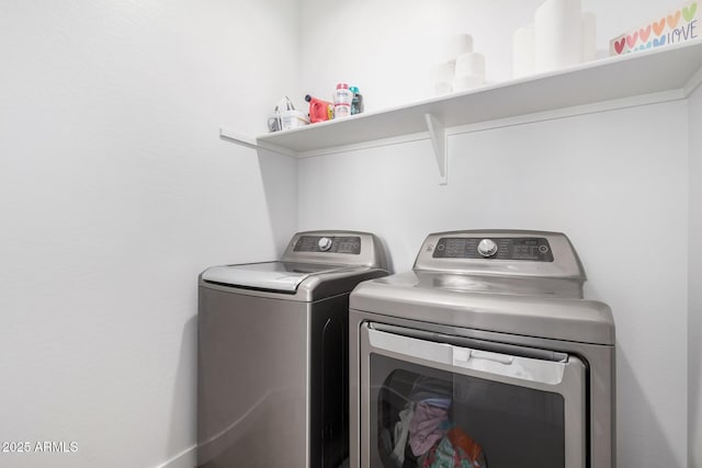 washroom with washing machine and clothes dryer