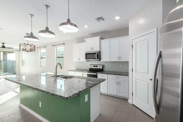 kitchen with pendant lighting, sink, stainless steel appliances, and white cabinets