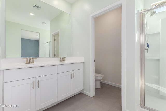 bathroom featuring vanity, toilet, and walk in shower