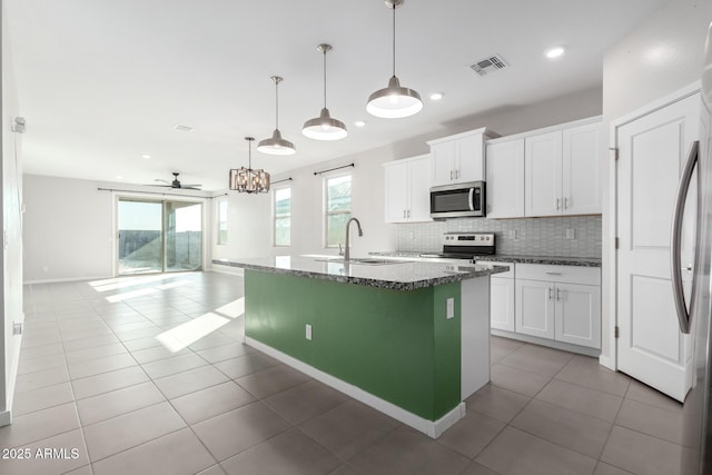 kitchen with sink, decorative light fixtures, white cabinets, and appliances with stainless steel finishes