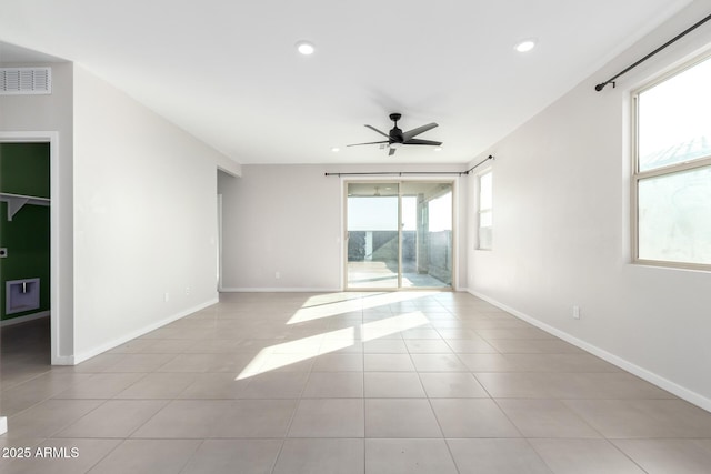 unfurnished room featuring light tile patterned floors and ceiling fan