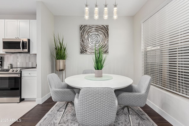 dining space featuring dark hardwood / wood-style flooring