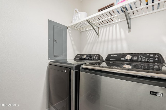 washroom featuring electric panel and washing machine and dryer