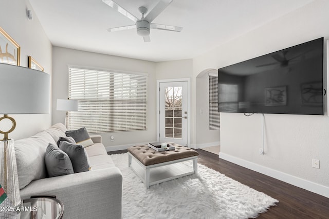 living room with dark hardwood / wood-style floors and ceiling fan