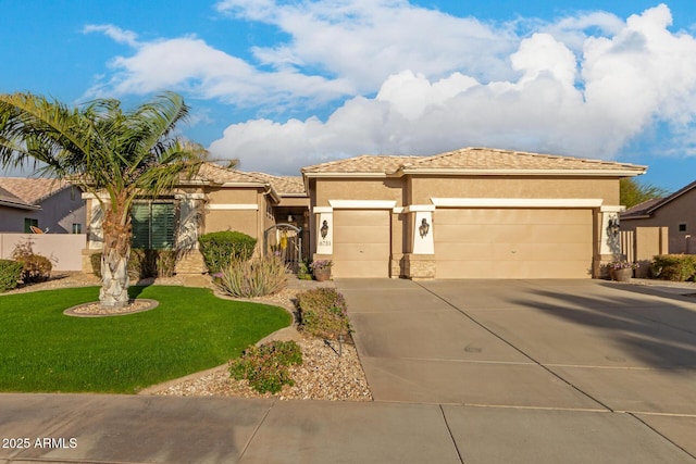 view of front of property with stucco siding, an attached garage, a front yard, and driveway