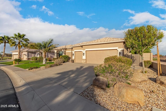 view of front of property featuring fence, stucco siding, an attached garage, and concrete driveway