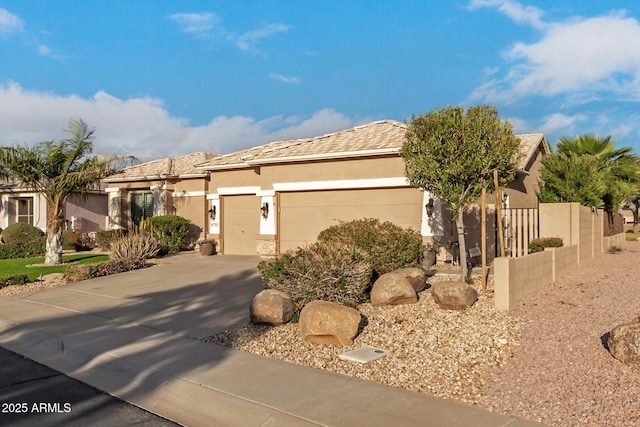 ranch-style home with stucco siding, concrete driveway, a garage, and fence