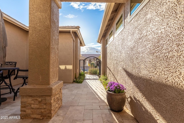 view of patio with a gate