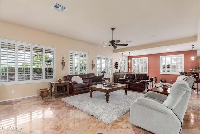living area with plenty of natural light, baseboards, visible vents, and ceiling fan