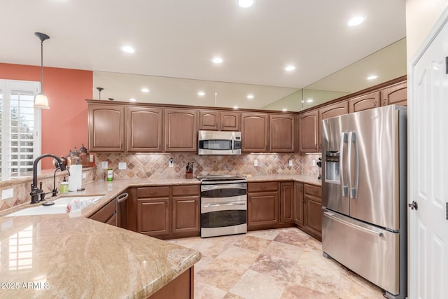 kitchen with decorative backsplash, a sink, recessed lighting, and appliances with stainless steel finishes