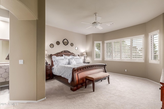 carpeted bedroom featuring baseboards, ceiling fan, and visible vents