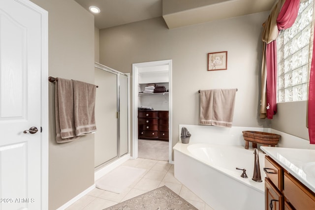 full bathroom with tile patterned floors, vanity, a stall shower, and a bath