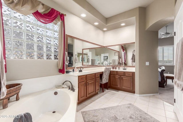 bathroom with a bath, recessed lighting, tile patterned flooring, and vanity