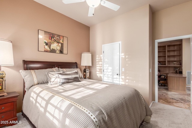 bedroom with a ceiling fan and carpet
