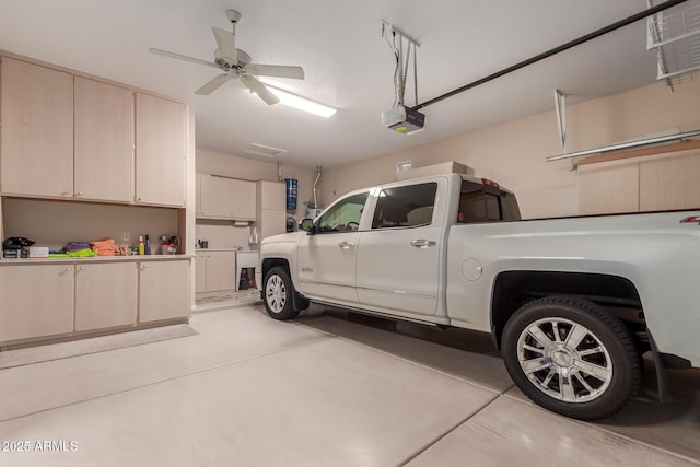 garage with a ceiling fan and a garage door opener