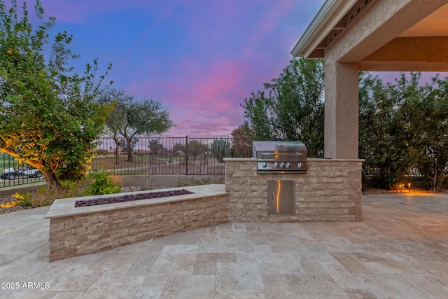 view of patio with a grill, exterior kitchen, and fence