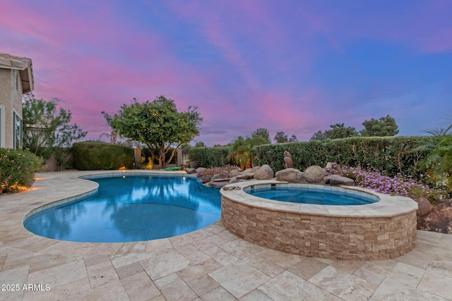 view of pool with a patio, a fenced in pool, and an in ground hot tub