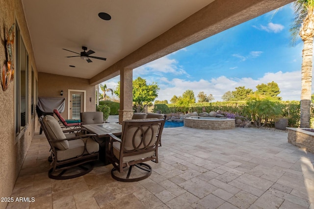 view of patio / terrace featuring a fenced in pool, an in ground hot tub, and a ceiling fan
