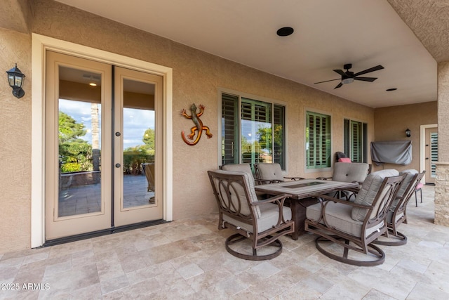 view of patio featuring ceiling fan, outdoor dining area, and french doors
