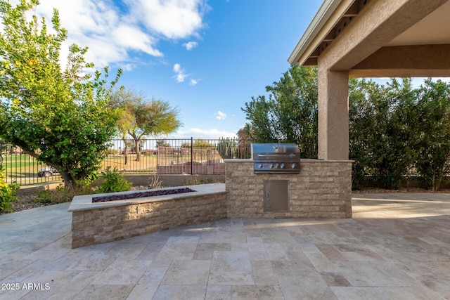 view of patio with area for grilling and fence