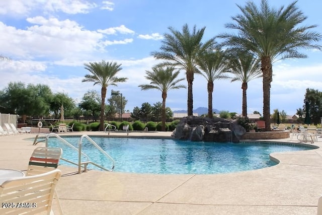 pool featuring fence and a patio
