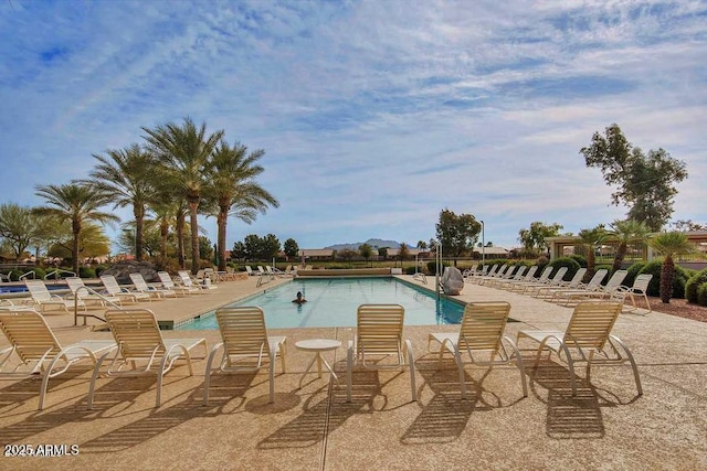 community pool with a patio area