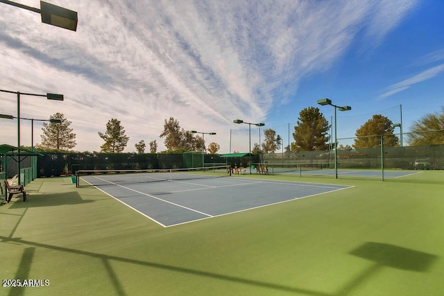 view of sport court featuring fence