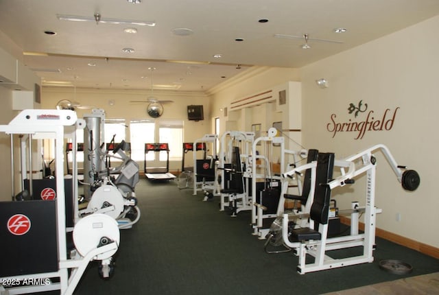 exercise room with baseboards and crown molding