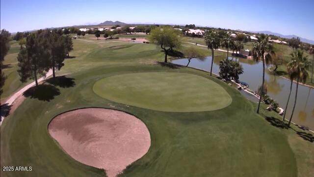 surrounding community featuring golf course view and a water view