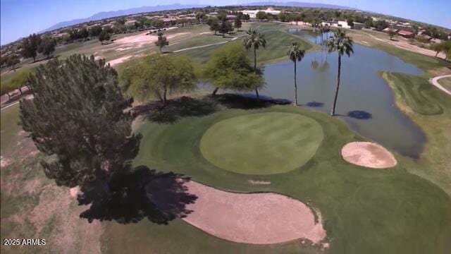 aerial view featuring golf course view and a water view