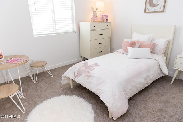 carpeted bedroom featuring baseboards